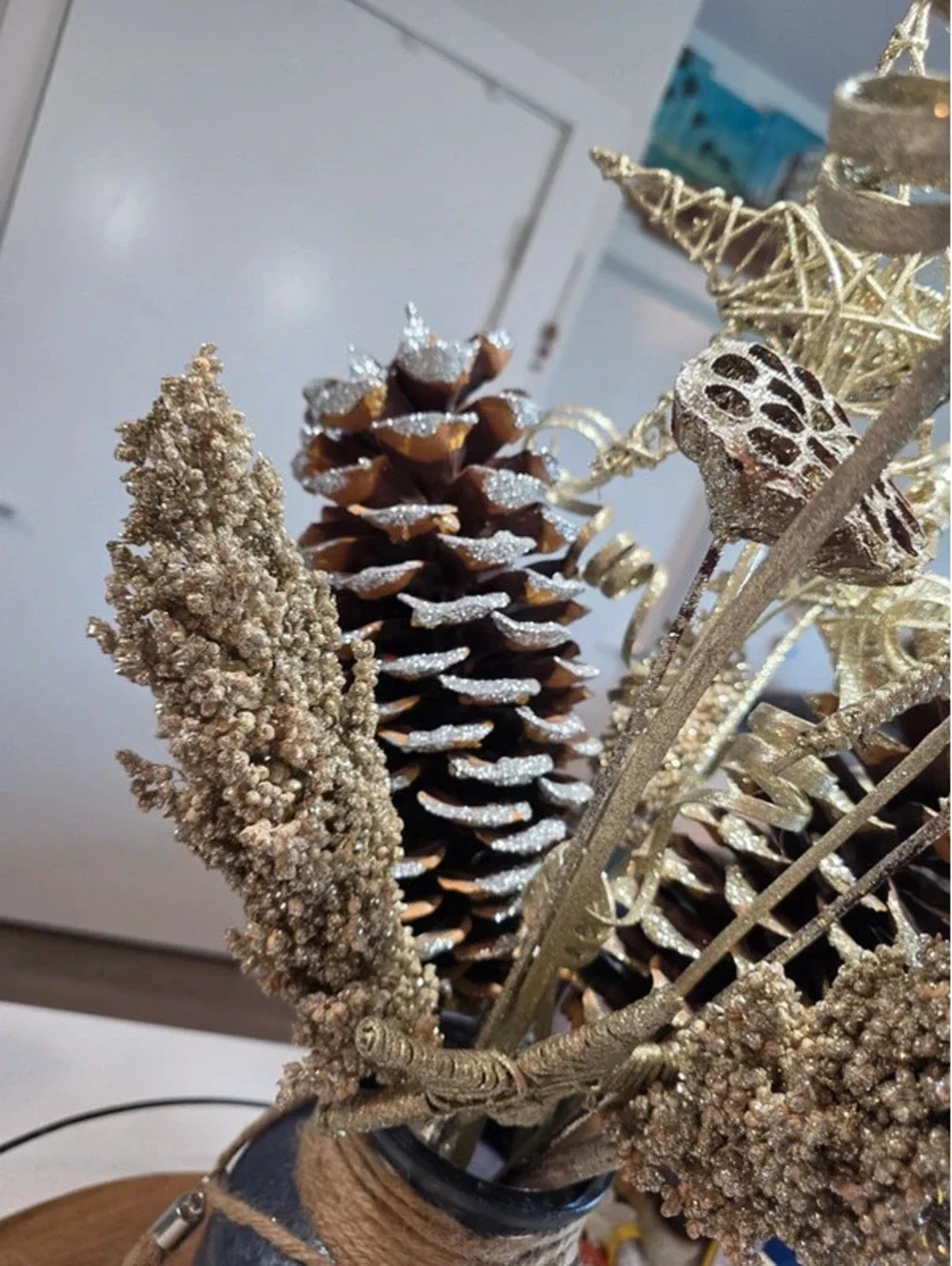 Rustic Decorative Pinecone and Star Arrangement in Glass Vase